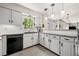Modern kitchen with granite countertops, white cabinets, and black appliances at 3585 Legacy Trce, Alpharetta, GA 30022