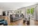Bright and airy living room with hardwood floors and access to the outdoor patio area at 3585 Legacy Trce, Alpharetta, GA 30022