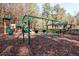 Community playground with swings, slides, and climbing structures surrounded by natural beauty at 3585 Legacy Trce, Alpharetta, GA 30022