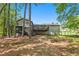 View of the large backyard and deck overlooking yard with wooded backdrop at 2022 Ramblewood Ne Ct, Marietta, GA 30062