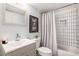 Charming bathroom with decorative vanity, sink, toilet, and tiled shower at 2022 Ramblewood Ne Ct, Marietta, GA 30062