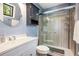 Blue bathroom featuring glass shower, medicine cabinet and forest view at 2022 Ramblewood Ne Ct, Marietta, GA 30062