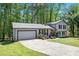 Well-maintained home with a long driveway, attached garage, and a neatly landscaped front yard at 2022 Ramblewood Ne Ct, Marietta, GA 30062