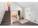 Inviting foyer with carpeted staircase, light gray walls, and a glimpse into the cozy living room at 2022 Ramblewood Ne Ct, Marietta, GA 30062