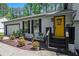 A welcoming yellow front door with decorative wreath, enhanced by manicured shrubs and attractive landscaping at 2022 Ramblewood Ne Ct, Marietta, GA 30062