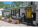 Close-up of a home's entrance, showing the bright yellow door, and landscaped front yard at 2022 Ramblewood Ne Ct, Marietta, GA 30062