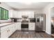 Bright kitchen with stainless steel appliances, white cabinets and wood-look flooring at 2022 Ramblewood Ne Ct, Marietta, GA 30062