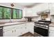 Galley kitchen with stainless appliances and a view of the forest at 2022 Ramblewood Ne Ct, Marietta, GA 30062