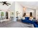 Bright living room with vaulted ceilings, plush blue seating, and view to the dining area at 2022 Ramblewood Ne Ct, Marietta, GA 30062