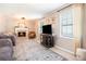 Bright living room with a fireplace, large windows, and neutral tones at 2022 Ramblewood Ne Ct, Marietta, GA 30062