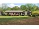 Charming ranch home with well-maintained lawn and colorful azalea bushes along the front at 4909 Woodhurst Way, Stone Mountain, GA 30088