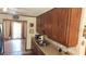 Galley kitchen featuring wood cabinetry, laminate countertops, and stainless steel sink at 4909 Woodhurst Way, Stone Mountain, GA 30088