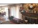 Bright living room features stone fireplace, wood floors, and natural lighting at 4909 Woodhurst Way, Stone Mountain, GA 30088