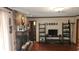 Comfortable living room featuring a stone fireplace and hardwood flooring at 4909 Woodhurst Way, Stone Mountain, GA 30088