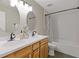 Bathroom featuring double sink vanity, modern fixtures, and a shower/tub at 1970 Glen Eves Dr, Roswell, GA 30076