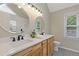 Bathroom features double sinks with white countertops and wood cabinets at 1970 Glen Eves Dr, Roswell, GA 30076