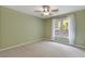 Bedroom features neutral walls and a window with scenic outdoor views at 1970 Glen Eves Dr, Roswell, GA 30076