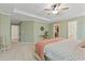 Bedroom with tray ceiling, plush carpet, and ensuite bathroom/walk-in closet at 1970 Glen Eves Dr, Roswell, GA 30076