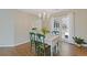 Elegant dining room featuring hardwood floors, a chandelier, and ample natural light from the large window at 1970 Glen Eves Dr, Roswell, GA 30076