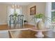 Charming dining room features hardwood floors, a chandelier, and classic table setting, perfect for Gathering gatherings at 1970 Glen Eves Dr, Roswell, GA 30076
