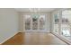 Bright dining room with hardwood floors and large windows overlooking the backyard at 1970 Glen Eves Dr, Roswell, GA 30076