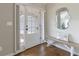 Bright entryway featuring a front door with side lights, a wooden bench, and a decorative mirror enhancing the space at 1970 Glen Eves Dr, Roswell, GA 30076