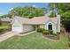 Charming home featuring a well-manicured lawn, complemented by a 2-car garage and mature trees in the background at 1970 Glen Eves Dr, Roswell, GA 30076