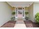 Inviting entryway with a stylish pink front door, flanked by potted plants, and warm lighting, creating a welcoming ambiance at 1970 Glen Eves Dr, Roswell, GA 30076
