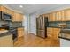 Modern kitchen with stainless steel appliances, dark countertops, and light wood cabinets at 1970 Glen Eves Dr, Roswell, GA 30076