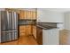 Bright kitchen featuring stainless steel appliances, sleek countertops, and light wood cabinets at 1970 Glen Eves Dr, Roswell, GA 30076