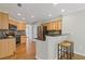 Modern kitchen with stainless steel appliances, a breakfast bar, and light wood cabinets at 1970 Glen Eves Dr, Roswell, GA 30076