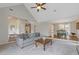 Spacious living room featuring vaulted ceilings, hardwood floors, a sofa, and a view to the dining area at 1970 Glen Eves Dr, Roswell, GA 30076