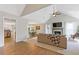 Bright and airy living room featuring a cozy fireplace, a vaulted ceiling with a fan, and seamless hardwood flooring at 1970 Glen Eves Dr, Roswell, GA 30076