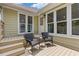 Outdoor patio with chairs, offering a relaxing space adjacent to the home's exterior at 1970 Glen Eves Dr, Roswell, GA 30076
