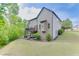 Backyard view featuring a spacious lawn, deck, and a lower level patio at 3097 Trinity Grove Dr, Dacula, GA 30019