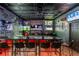 Dynamic bar area equipped with TVs, sports memorabilia, and comfortable seating, ideal for hosting game nights at 3097 Trinity Grove Dr, Dacula, GA 30019
