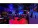 Entertainment space with a large bar, multiple televisions, and atmospheric lighting, creating an exciting ambiance at 3097 Trinity Grove Dr, Dacula, GA 30019