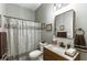 Bathroom featuring a vanity with granite countertop, subway tile backsplash, and decorative mirror at 3097 Trinity Grove Dr, Dacula, GA 30019