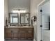 This bathroom features a double vanity with beautiful countertops, framed mirrors, and nice fixtures at 3097 Trinity Grove Dr, Dacula, GA 30019