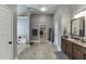 This bathroom features a double vanity, a bathtub, a walk-in shower, and tiled flooring at 3097 Trinity Grove Dr, Dacula, GA 30019