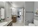 This bathroom has a toilet, sink, shower, and a mirror. The design is simple, practical and efficient at 3097 Trinity Grove Dr, Dacula, GA 30019