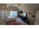 This cozy bedroom features a bed, a desk, a dresser, a ceiling fan, and a window at 3097 Trinity Grove Dr, Dacula, GA 30019