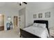 This bedroom features a bed, a desk, a dresser, and a bathroom connected with a door at 3097 Trinity Grove Dr, Dacula, GA 30019