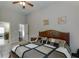 Spacious bedroom with a decorative headboard, cozy quilt, and access to an ensuite bathroom at 3097 Trinity Grove Dr, Dacula, GA 30019