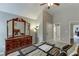 Spacious bedroom featuring a dresser with mirror, neutral tones, and access to an ensuite bathroom at 3097 Trinity Grove Dr, Dacula, GA 30019