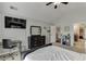 This bedroom features a bed, a desk, a dresser, a ceiling fan, and ample closet space at 3097 Trinity Grove Dr, Dacula, GA 30019