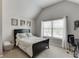 Cozy bedroom featuring neutral tones, natural light from a large window, and an inviting bed at 3097 Trinity Grove Dr, Dacula, GA 30019