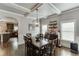 Formal dining area featuring coffered ceilings, hardwood floors, and a modern chandelier at 3097 Trinity Grove Dr, Dacula, GA 30019