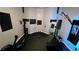 Well-equipped home gym featuring modern fitness equipment, mirrored wall, and soundproofing, ideal for private workouts at 3097 Trinity Grove Dr, Dacula, GA 30019