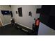 Dedicated exercise room with a rowing machine, TV, and wall-mounted accessories for a complete workout experience at 3097 Trinity Grove Dr, Dacula, GA 30019